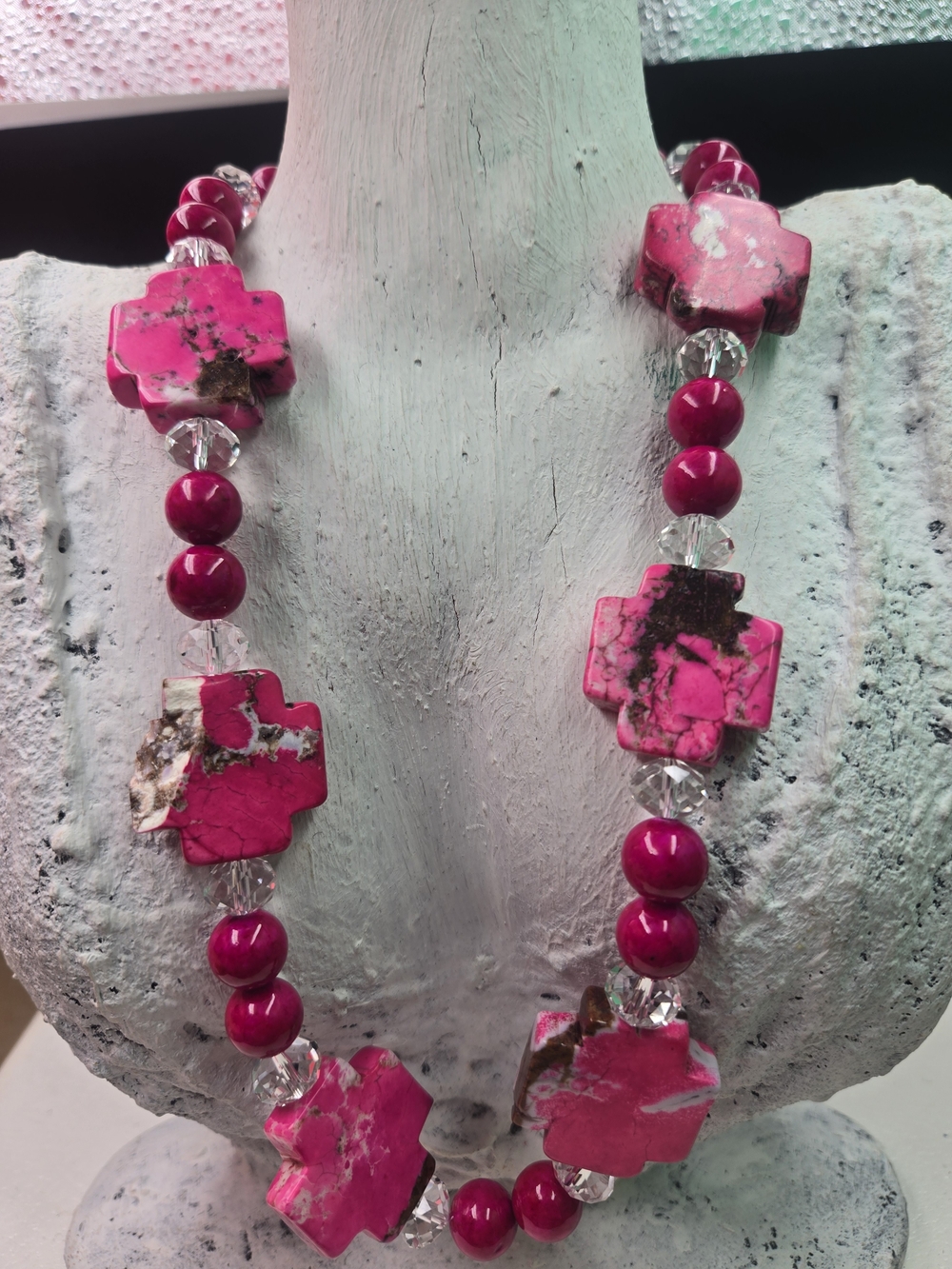statement necklace featuring chunky, pink-dyed howlite cross beads paired